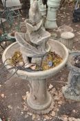 A MODERN COMPOSITE WATER FEATURE with a column and bowl featuring foliate detail standing on a