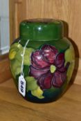 A MOORCROFT POTTERY GINGER JAR AND COVER, the blue-green ground decorated in a red/purple clematis