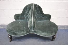 A VICTORIAN TWO SEAT CONVERSATION SOFA, with a buttoned back and covered in green fabric, on