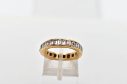 A YELLOW METAL DIAMOND FULL ETERNITY RING, the band ring channel set with twenty seven princess