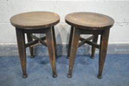 A PAIR OF 19TH CENTURY OAK CIRCULAR STOOLS, on four tapered legs, and padded feet united by cross