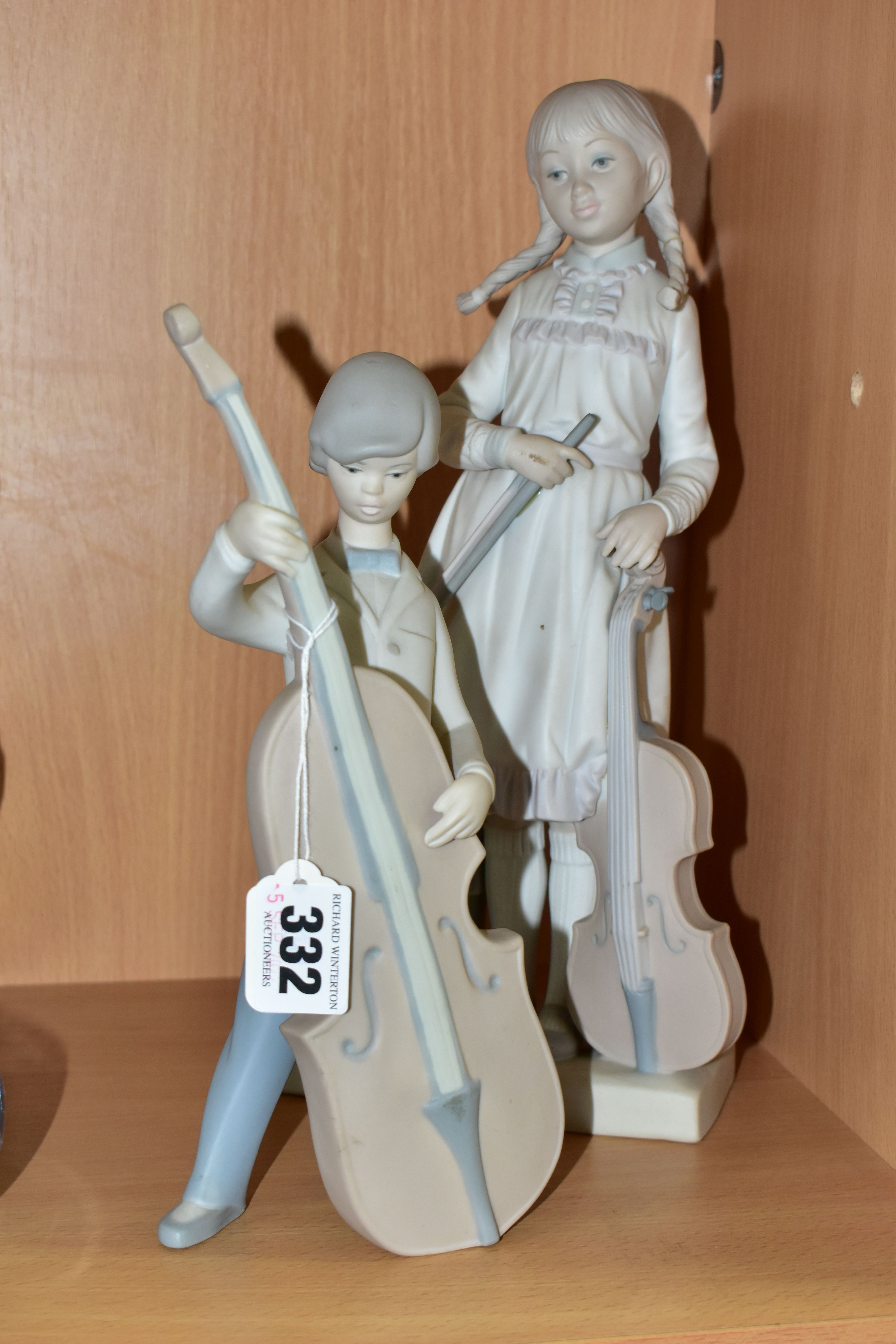 TWO LLADRO FIGURINES WITH A MUSICAL THEME, in matt finish, comprising Boy With Double Bass 4615,