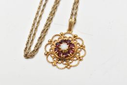 A 9CT GOLD GEM SET PENDANT AND CHAIN, the pendant of an openwork circular form, centring on an eight