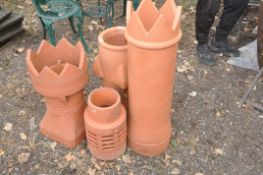 FOUR TERRACOTTA CHIMNEY TOPPERS of various designs and sizes the tallest being 94cm