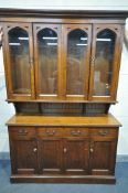A 20TH CENTURY GOTHIC OAK DRESSER, the top with four glazed doors, base with three drawers above
