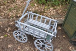 A MODERN FOUR WHEELED GARDEN CART with iron banded wheels and straps width 68cm, length without