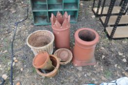 FIVE TERACOTTA PLANT POTS of various sizes and shapes and two chimney pots the tallest being 63cm