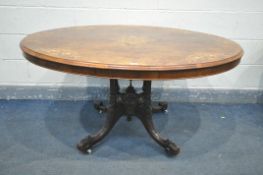 A LATE VICTORIAN WALNUT OVAL TILT TOP LOO TABLE, with marquetry inlay, turned supports, fluted