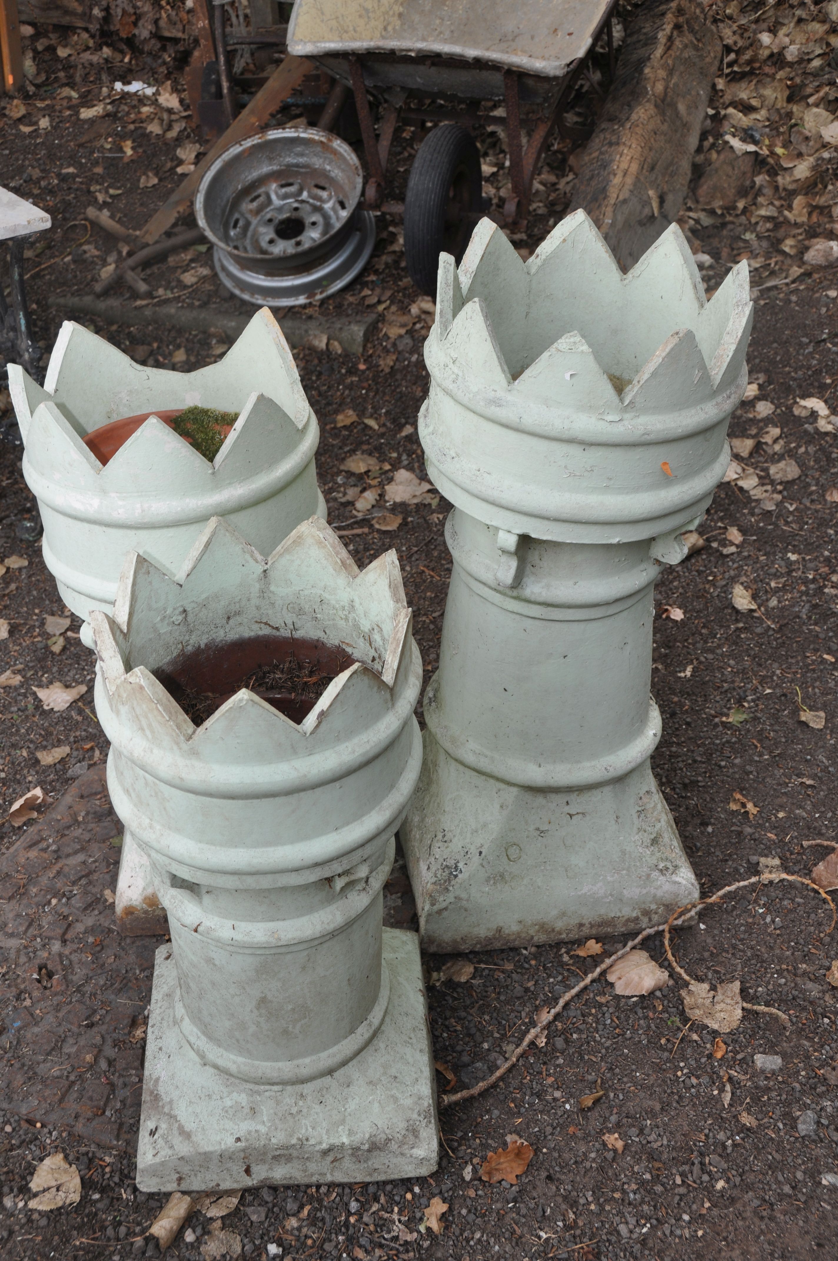 THREE CROWN TOPPED VINTAGE CHIMNEY POTS of different heights the tallest being 87cm the smallest