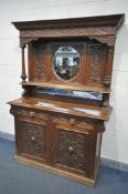 A LATE VICTORIAN CARVED OAK MIRROR BACK SIDEBOARD, the top with a circular bevelled mirror central