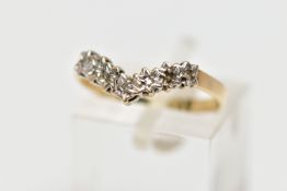 A 9CT GOLD DIAMOND WISHBONE RING, designed as a series of illusion set diamonds, one diamond