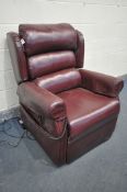 A RED LEATHER ELECTRIC RISE AND RECLINE ARMCHAIR (PAT pass and working)