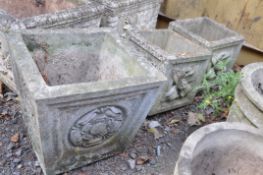 A PAIR OF SMALL COMPOSITE SQUARE GARDEN PLANTERS with foliate detail to each facet width and depth