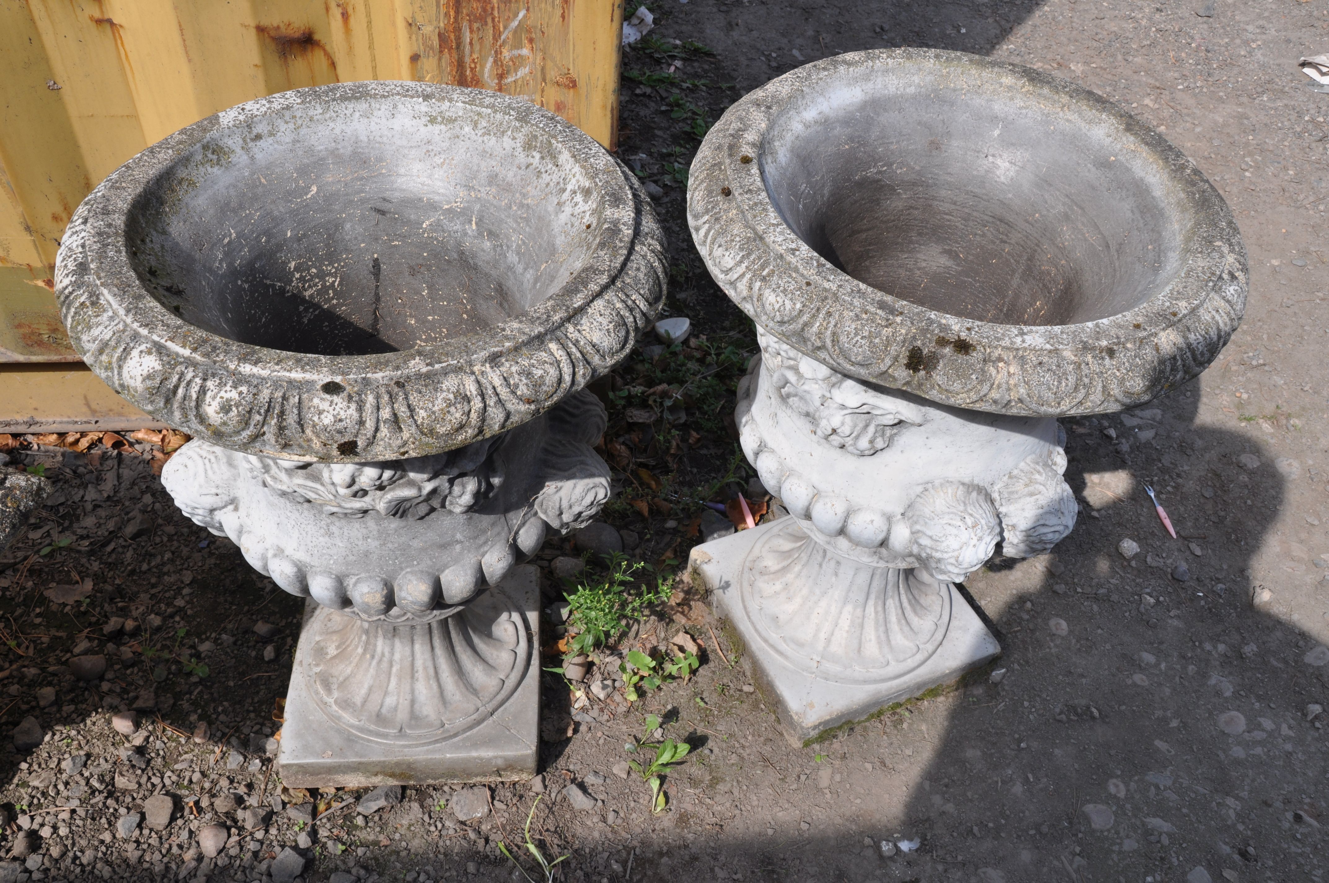 A PAIR OF MODERN COMPOSITE GARDEN URNS one piece in construction with dual mask motifs on opposing