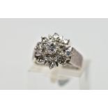 A WHITE METAL DIAMOND FLORAL CLUSTER RING, comprising a brilliant cut central diamond with single