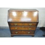 A GEORGIAN OAK AND MAHOGANY CROSS BANDED FALL FRONT BUREAU, with fitted interior, above three