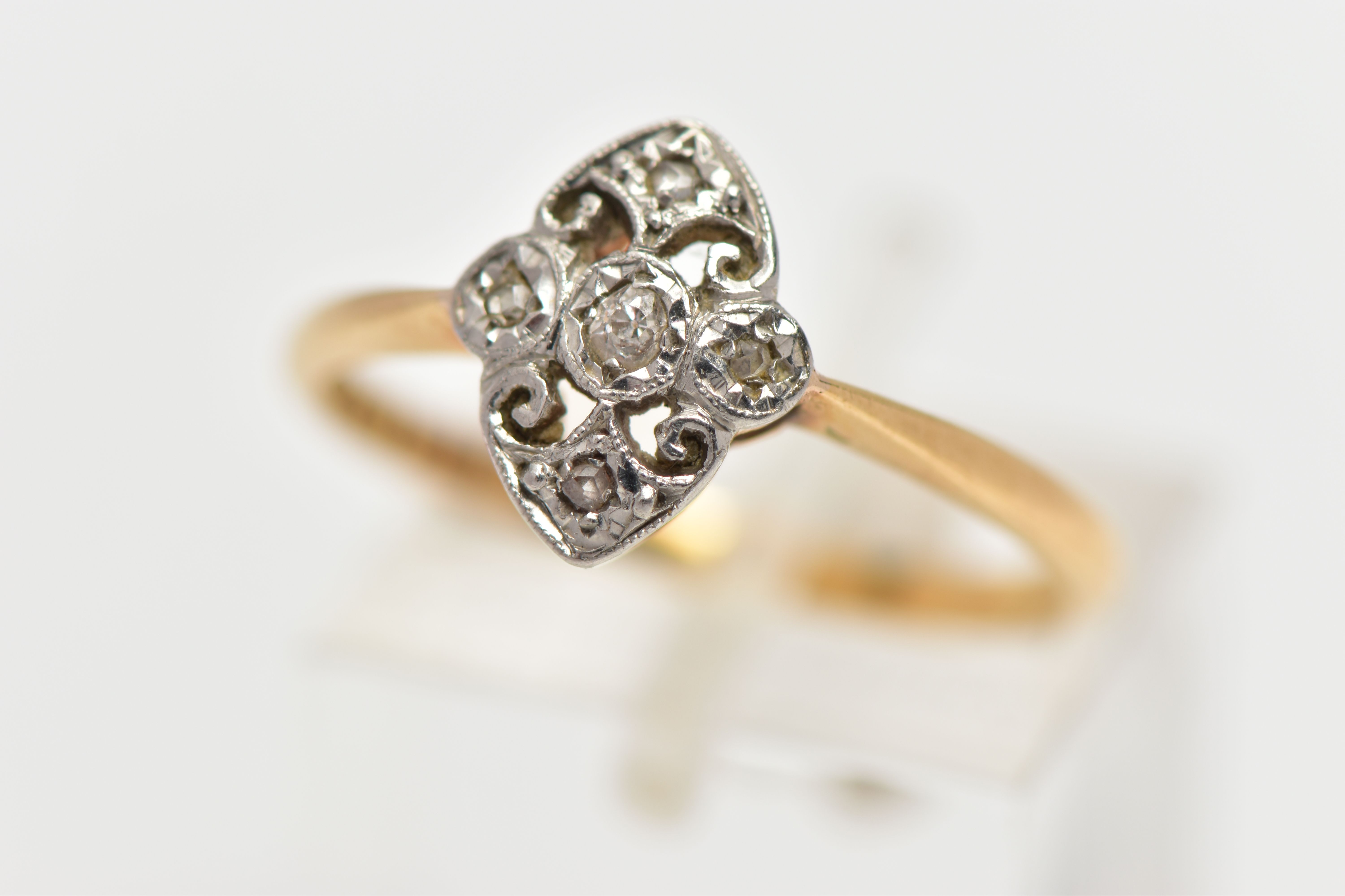 A YELLOW AND WHITE METAL DIAMOND DRESS RING, of openwork design the old and rose cut diamond panel