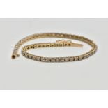 A 9CT YELLOW GOLD DIAMOND LINE BRACELET, designed as a series of approximately sixty two uniform