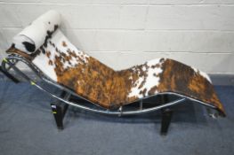 IN THE MANNER OF LE CORBUSIER, a cow hide lc4 chaise longue, with a chrome frame, on a metal frame