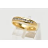 AN 18CT YELLOW GOLD DIAMOND BAND RING, set with a line of eleven round brilliant cut diamonds,