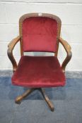 A 20TH CENTURY OAK SWIVEL OFFICE CHAIR, with open armrests, burgundy and studded upholstery (