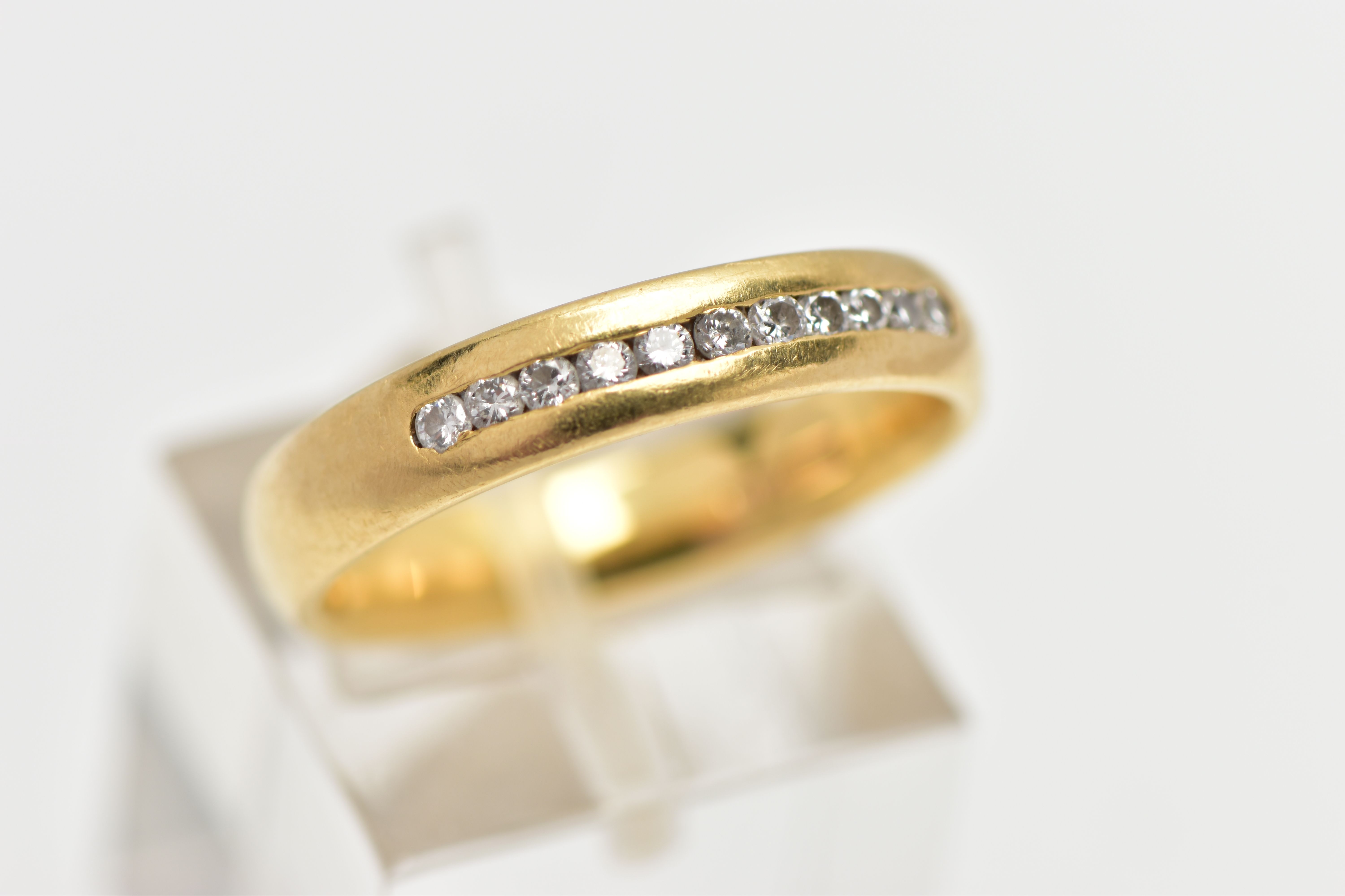 AN 18CT YELLOW GOLD DIAMOND BAND RING, set with a line of eleven round brilliant cut diamonds, - Image 4 of 4