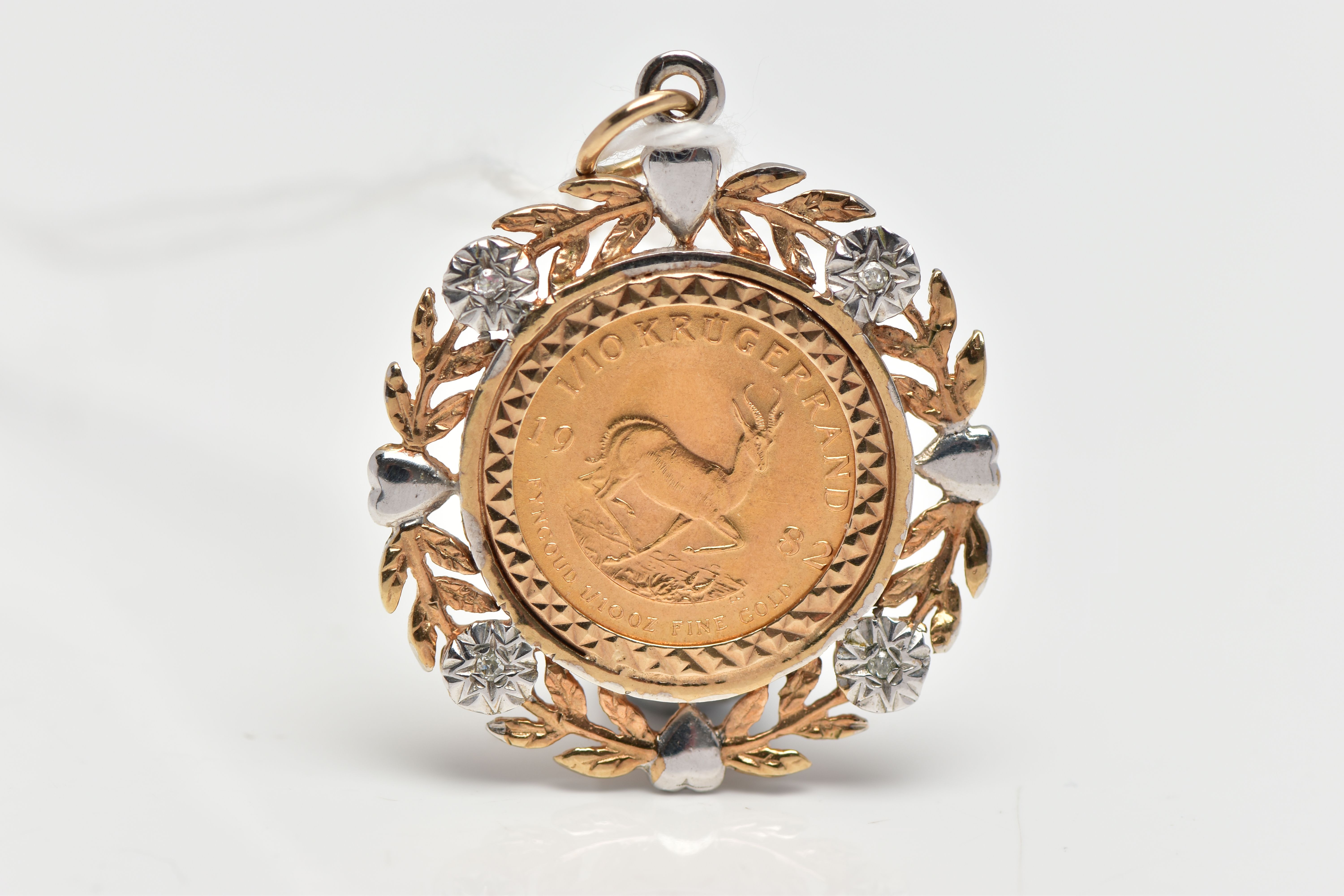 A YELLOW AND WHITE 9CT GOLD DIAMOND SET PENDANT MOUNTED WITH A 1/10 OZ KRUGERRAND, the pendant set