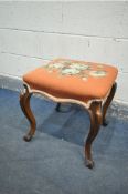 A VICTORIAN WALNUT STOOL, with a pink floral needlework fabric, on cabriole legs, 46cm x height