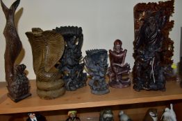 EIGHT ORIENTAL AND ASIAN CARVED WOODEN SCULPTURES, to include an intricate high relief carved panel,