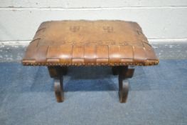 A 20TH CENTURY TANNED LEATHER STOOL, the top with woven and studded edge, and two England shield