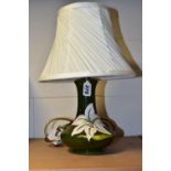 A MOORCROFT POTTERY 'BERMUDA LILY' TABLE LAMP, the tube lined pattern on a green ground, height