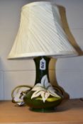 A MOORCROFT POTTERY 'BERMUDA LILY' TABLE LAMP, the tube lined pattern on a green ground, height