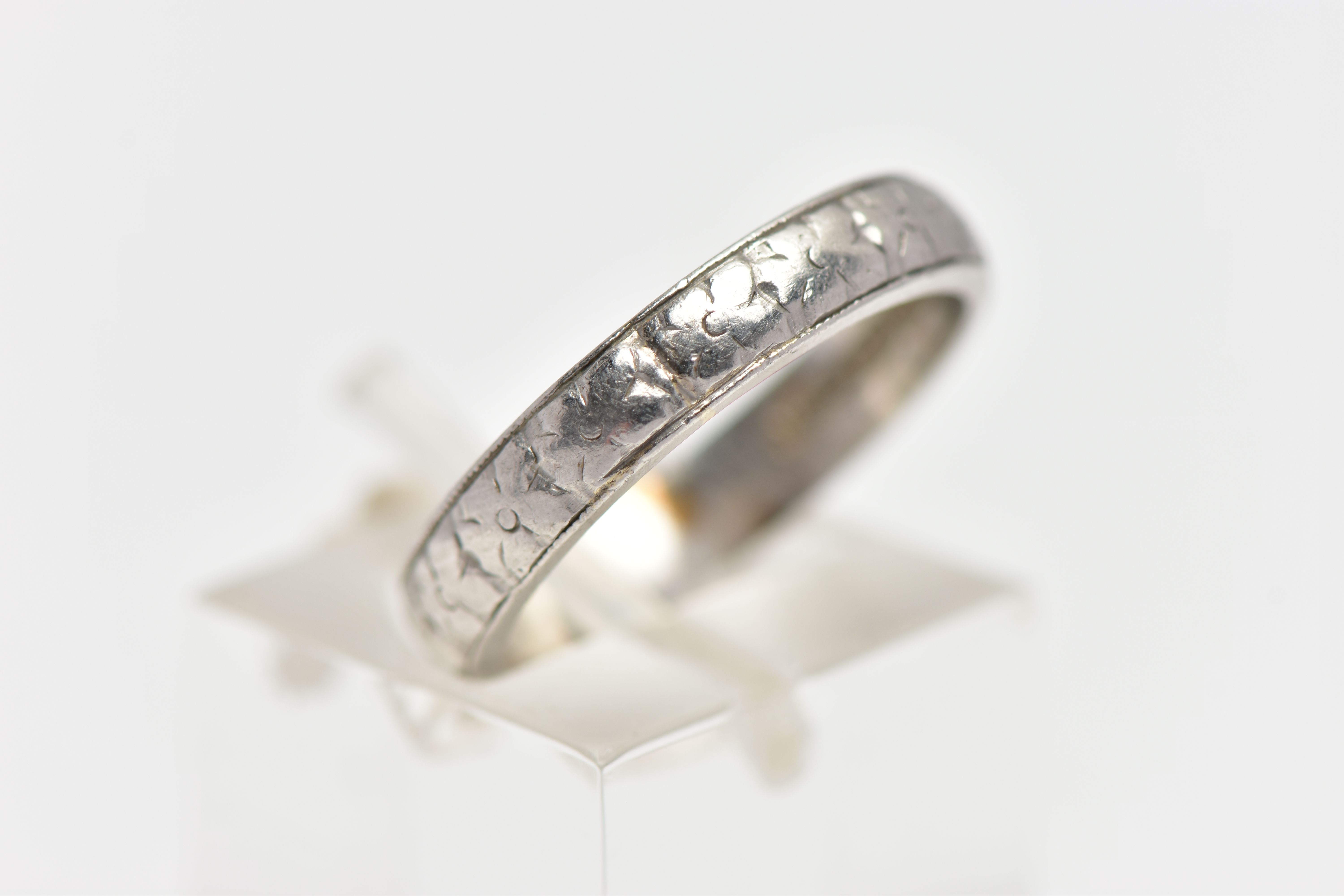 A WHITE METAL BAND RING, decorated with a slightly worn floral pattern, stamped 'HA Platinum', - Image 3 of 4