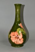 A LARGE MOORCROFT POTTERY BOTTLE VASE, in the coral 'Hibiscus' pattern on a green ground, height