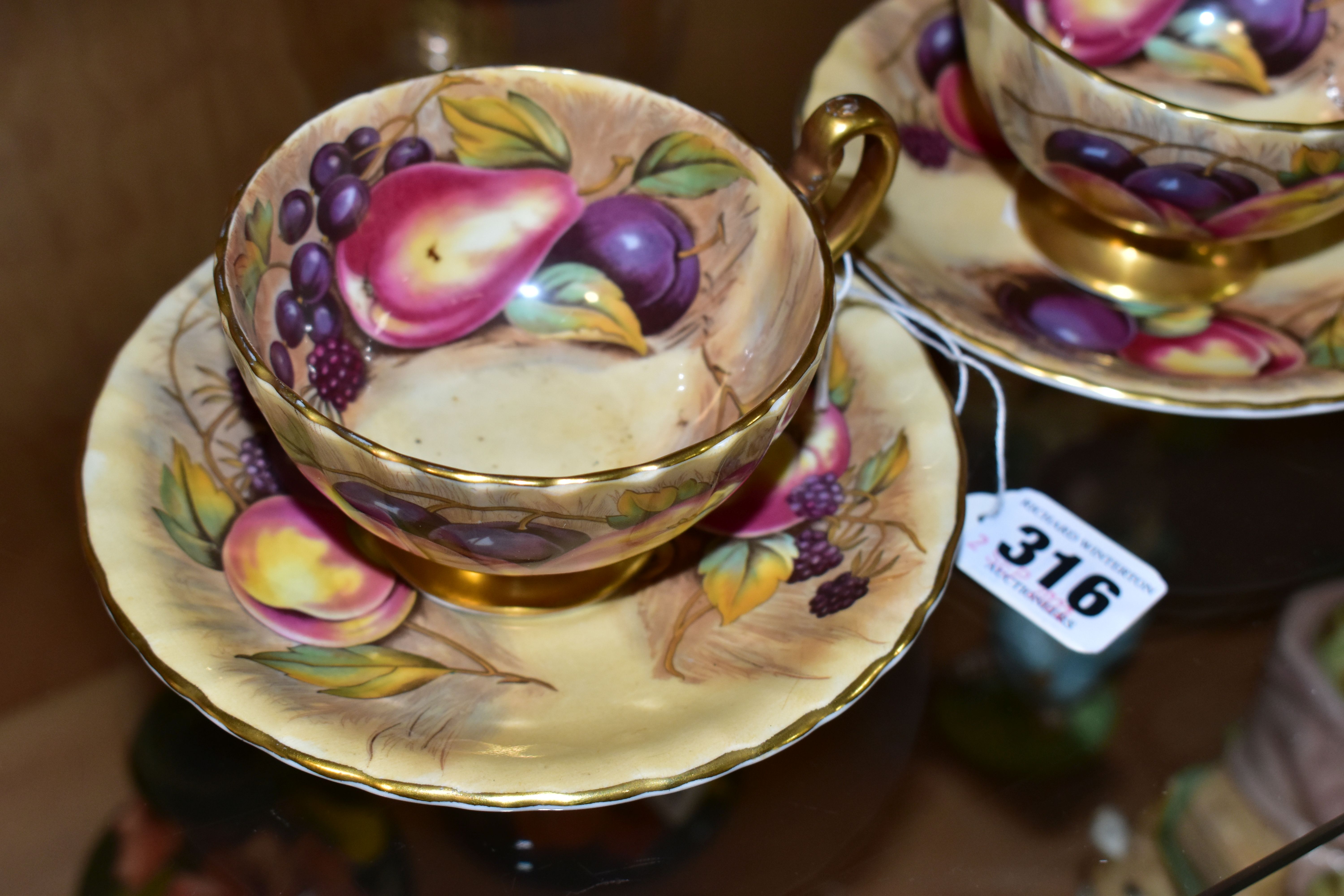 A PAIR OF AYNSLEY ORCHARD GOLD TEA CUPS AND SAUCERS, with gilt handles and rims, printed with - Image 2 of 4