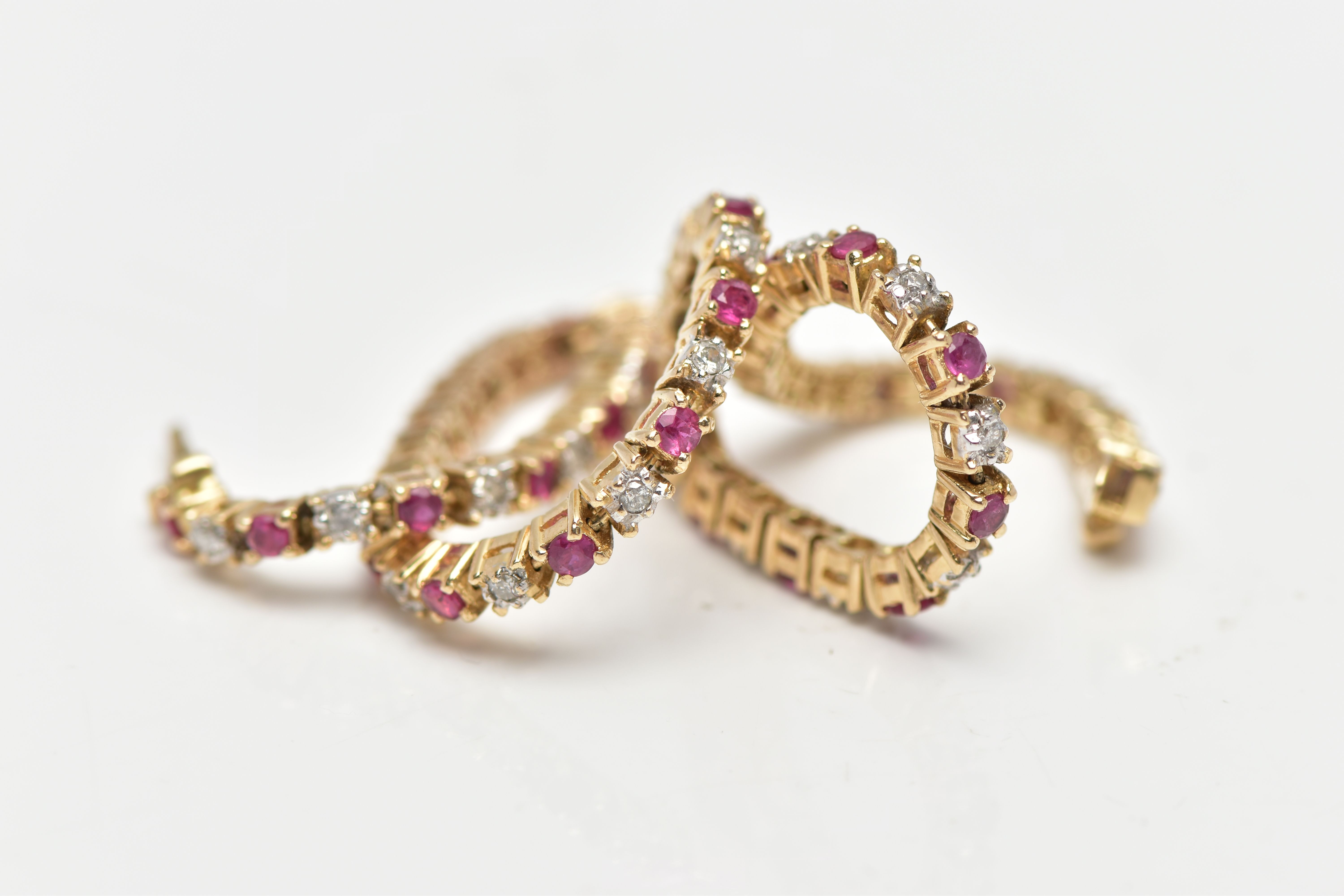 A 9CT YELLOW GOLD DIAMOND AND RUBY LINE BRACELET, set with approximately thirty one round - Image 3 of 3