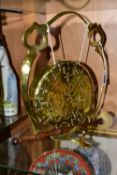 A BRASS TABLE GONG, suspended from a brass frame, with wooden handled beater, frame is stamped