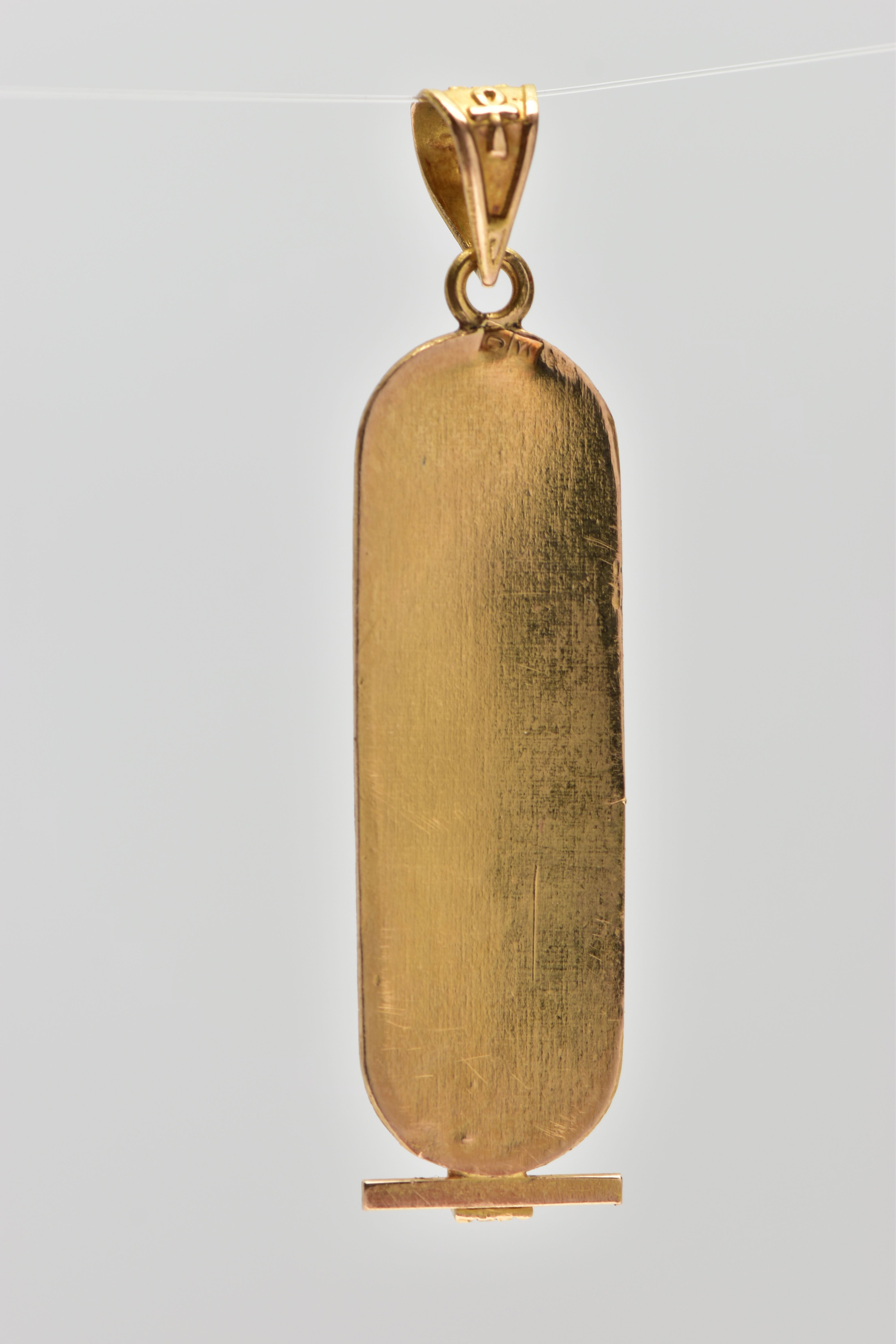 A YELLOW METAL EGYPTIAN CARTOUCHE PENDANT, of an oval outline displaying hieroglyphics, fitted - Image 2 of 2