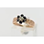 A 9CT GOLD SAPPHIRE AND DIAMOND CLUSTER RING, centring on an illusion set, single cut diamond,