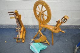 A 20TH CENTURY BEECH SPINNING WHEEL, a bag of parts, and a loom