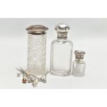 A SELECTION OF GLASS BOTTLES WITH SILVER LIDS AND STICK PINS, to include an early 20th century