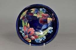 A MOORCROFT POTTERY ORCHID PATTERN LARGE FOOTED BOWL, with tube lined purple, pink and yellow