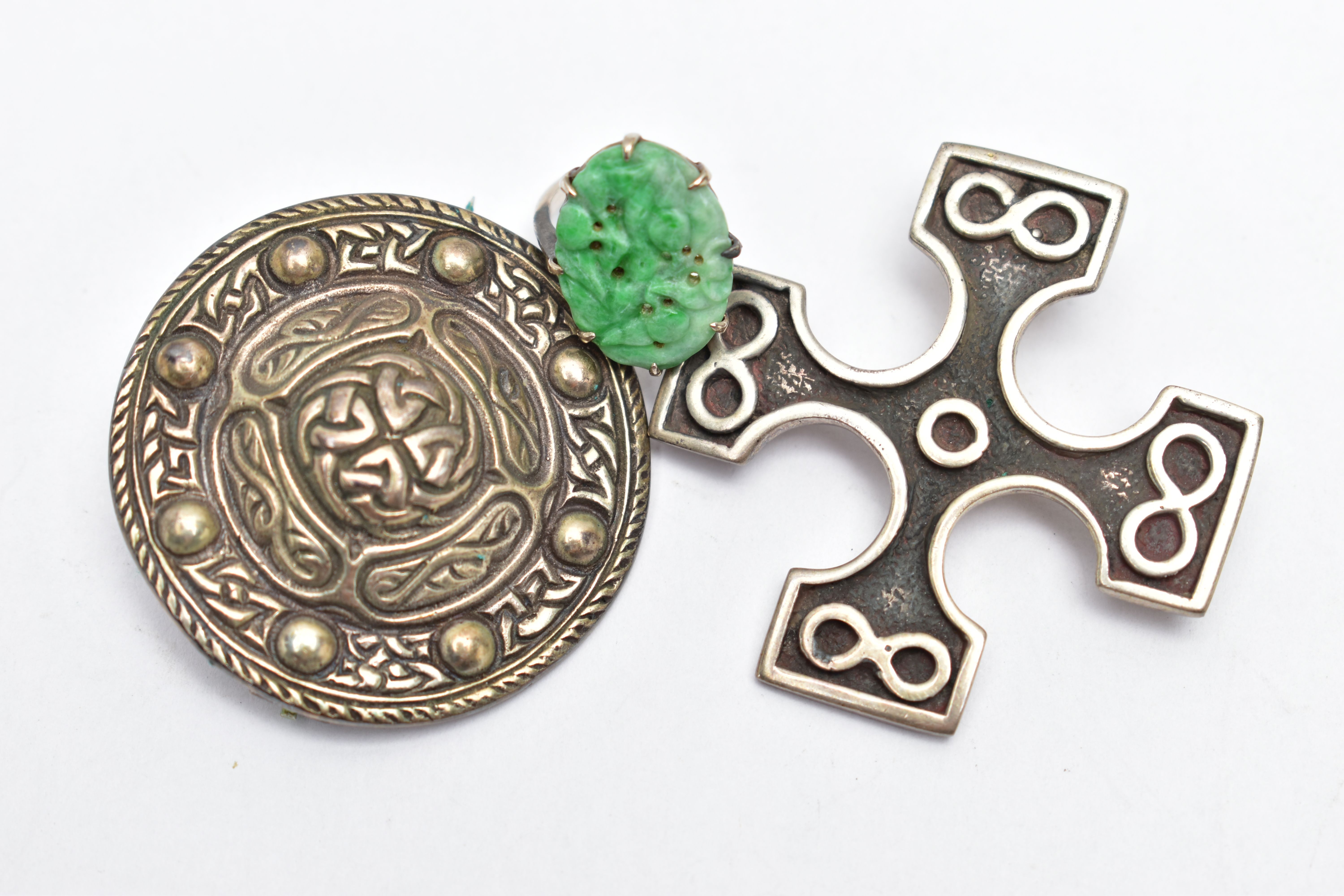 TWO SCOTTISH SILVER BROOCHES, the first a silver cross, detailed with four infinity symbols,