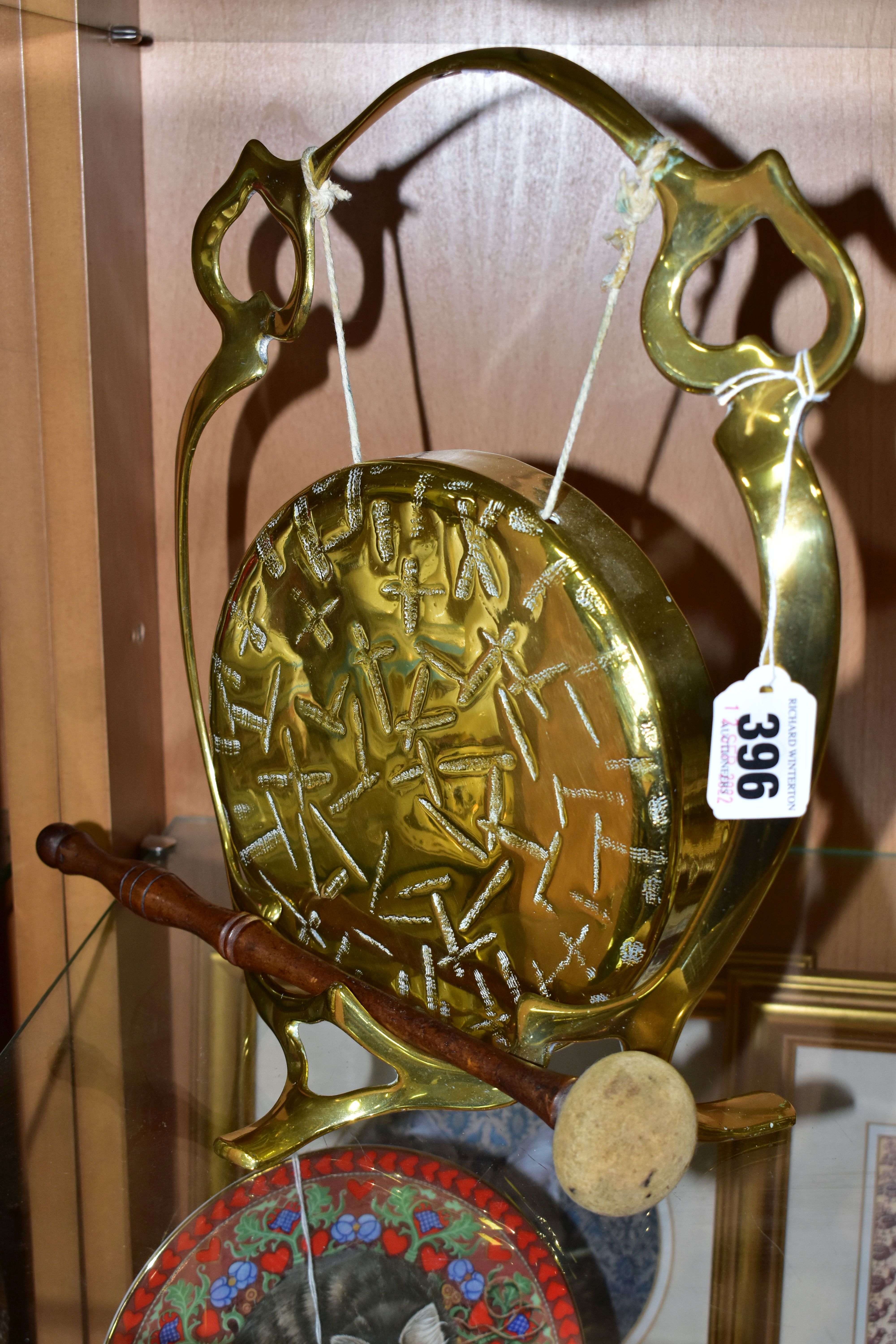 A BRASS TABLE GONG, suspended from a brass frame, with wooden handled beater, frame is stamped - Image 2 of 3