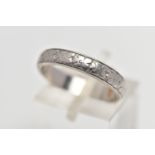 A WHITE METAL BAND RING, decorated with a slightly worn floral pattern, stamped 'HA Platinum',