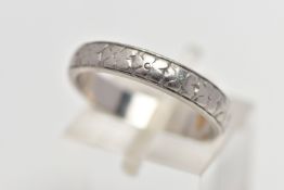 A WHITE METAL BAND RING, decorated with a slightly worn floral pattern, stamped 'HA Platinum',