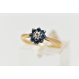 A YELLOW METAL DIAMOND AND SAPPHIRE CLUSTER RING, the brilliant cut diamond centre with circular cut