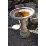 A MODERN COMPOSITE BIRD BATH on fluted and foliate detailed column base and a foliated detailed bowl