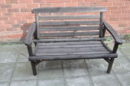 A MODERN PINE WOOD GARDEN BENCH with slatted seat and back width between arms 110cm (Condition:-