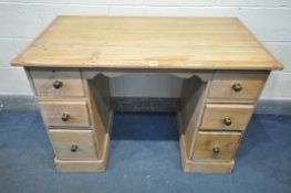 A 19TH CENTURY PINE KNEE HOLE DESK, with two banks of three drawers, width 114cm x depth 62cm x